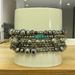This stretch handmade bracelet is sold as a set of 5. The metal beads are various size and shape, there are some turquoise color seed beads.